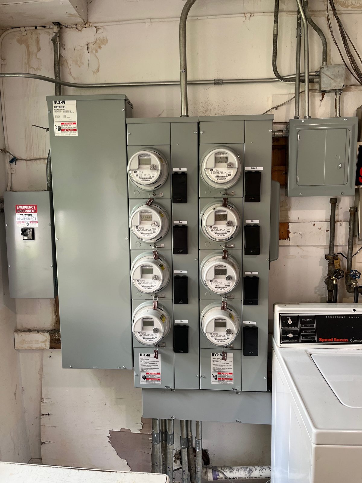 Eight-meter service with new conduit and labeled meter positions